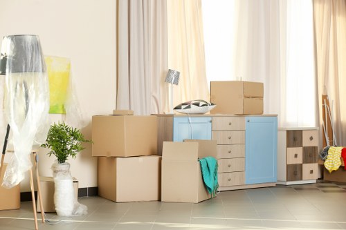 Furniture collection team handling a bulky sofa pick-up in a Belsize Park flat
